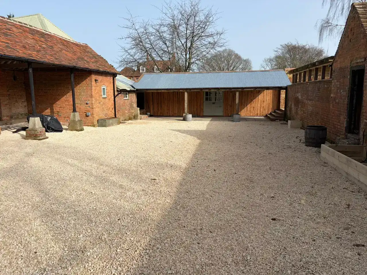 Black-clad outbuilding: weatherboarding installation in progress